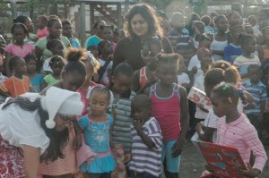 Priya Manickchand gets help in distributing the toys in Bare Root