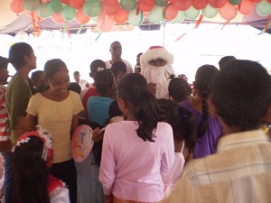 Some of the children flock Santa Claus at one of the parties 