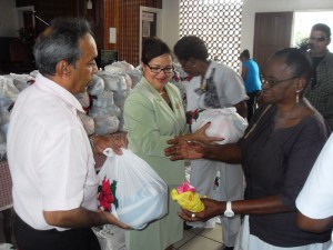 Mr. Edward Boyer and Amanda St Aubyn  share the food items to the beneficiaries.