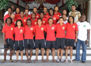 The Suriname female national team and their management staff take  time out for a photo yesterday at the Ocean View International Hotel.  