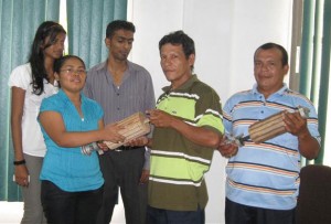 Project Co-ordinator, MOAA, Sharon Austin handing over the graters to Toshao Ronald Adolphus of Black Water Savannah, Region One