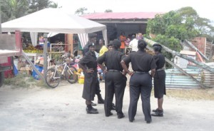 Constables overlooking the stall being emptied before its demolition  