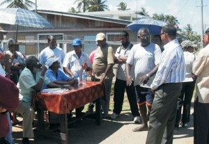 A GWI employee works diligently to disconnect the illegal  connection made by residents in the Tuschen area. 