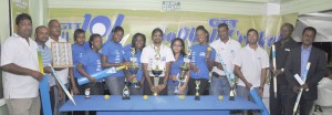 Top Brass of GT&T, Guyana Softball League and co-sponsors pose with the GT&T 1010 girls following the unveiling of trophies and top prize for the nationwide knock-out competition.