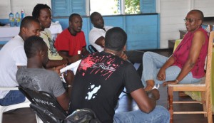  Dr Janice Jackson chats with a group of National cricketers during a Claude Raphael organized self examination session yesterday. 