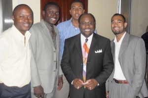 Dr. Myles Munroe in the company of young  men that were moved by his speech. 