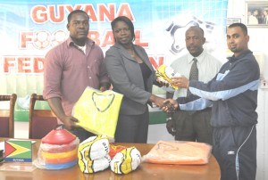 President of the National Association of Women’s Football Vanessa Dickson (2nd left) collecting one of the balls from Peter Barry. GFF President Colin Klass is 2nd right while 2nd Vice President Franklin Wilson is at left.