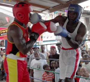 Dennis Thomas (right) scores with a right hand  in one of his few bright moments in the fight. 