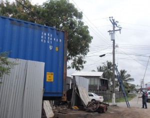 GPL reconnecting the electricity supply that was disrupted. The container can be seen touching the electrical wires.