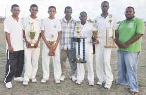 The successful captains pose with their silverware and management staff. From left, Simon Boodhoo, Loyyden Leiws (U-15), Dominic Rickey (U-17), Patrick Lewis – Manager, Shemaine Campbell (female), Eon Hooper (U-19 & 23) and Munesh Singh – Coach.   