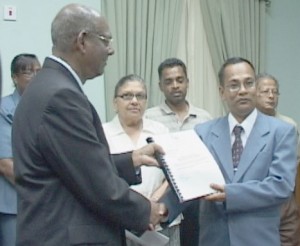 Deodat Sharma (right) as he presented the 2007  report to the Speaker of the national Assembly