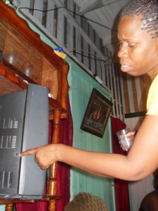 Vanessa Washington points to the bullet hole on her television set 