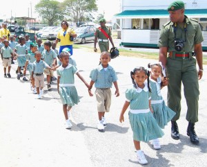  Some army ranks escort the visiting children and their teachers around Camp Ayanganna