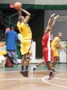 Central Mackenzie’s forward, Marvin Hartman (left) goes up for a three-point jumper but the much more diminutive point guard, Aubrey Austin confronts him in the featured game of the Mackeson National Super Ward Saturday night.