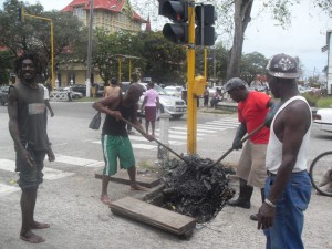 Digging out the garbage from the manhole on Croal Street 