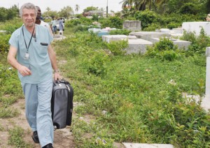 Foreign Pathologist Dr Valery Alexandrov makes his way into the cemetery to perform the second autopsy