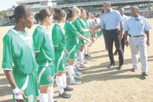 President Dr. Bharrat Jagdeo meeting Lady Jags team members before their game against Suriname at the GCC Ground. At right is GFF President Colin Klass. (Franklin Wilson photo) 