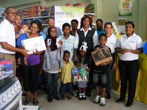 Marketing Coordinator of Bryden and Fernandes Mark Kendall (left) with winners of the Blue Band’s “Grow Well Live Well” second presentation ceremony and Representatives at Bounty Supermarket, Water Street. 