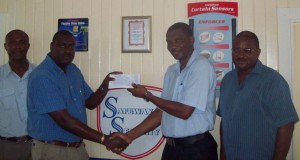 SAFEWAY SECURITY’S Eon Caesar (left) presents the sponsorship cheque to GCA President Roger Harper at yesterday’s launching of the GCA’s spin bowling and batting against spinners clinic. GCA’s Neil Barry (left) and Lance Hinds (right) share the moment.  