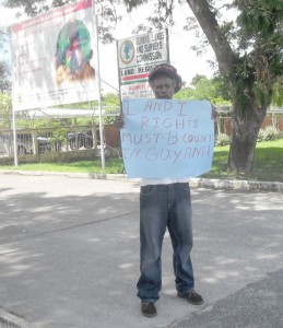 Michael Cordis stagies a one-man picket outside the Lands and Surveys Department. 