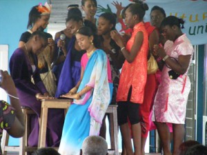 Students garbed in ethnic wear reflecting Guyana's diversity. 