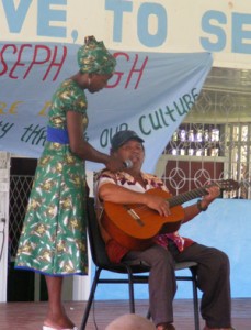 The Mighty Chief singing of one of his favourites. Holding the microphone for him is Physical Education Teacher, Nima Flue-Bess. 