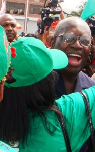 A supporter hugs President Ronald Venetiaan after he voted yesterday.