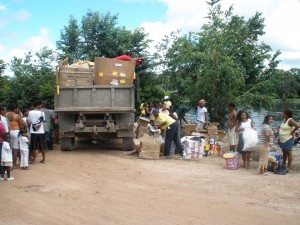 Residents of Kwakwani assisting Food for the Poor  officials in the distribution exercise. 