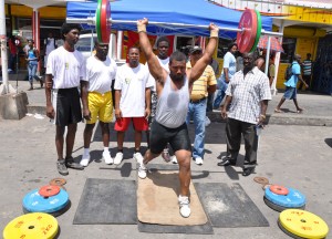 Multiple national weightlifting champion Sean Cozier  demonstrates the clean and jerk in the presence of fellow lifters  including GAWA Secretary (2nd left) and President Frank Tucker (right). 