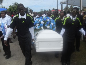 Members of the Melanie Damishana youth development football  team carry their colleague’s casket from his residence.