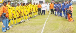 John Fernandes Insurance Services Manager Terence Solomon (second right centre) and GHB President Philip Fernandes takes a photo op with the players and umpires shortly before the start of play yesterday. 