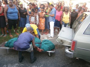 Undertakers taking away the charred remains.