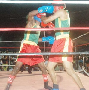 BOOM! Clairmont Gibson (left) lands a right hand hook flush in the face of Kevin Ting-A-Kee in the Lightweight Division of the Mackeson Fight Night at the Amelia’s Ward Bus Park in Linden. 