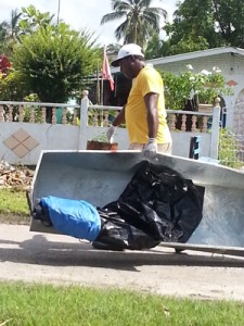 A worker from the Ezekiel Funeral Service heading to the backdam behind Wales, West Demerara, to retrieve the unidentified body. 