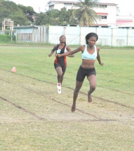 Cassie Small about to cross the finish line ahead of Tiana Barker.