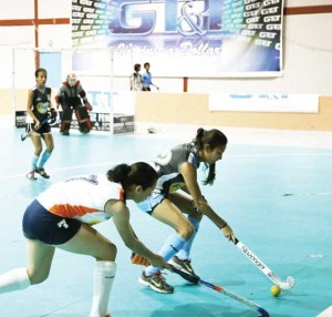 Samantha Fernandes (right) of the Spartans being tackled by GCC Tigers right back Trisha Woodroffe