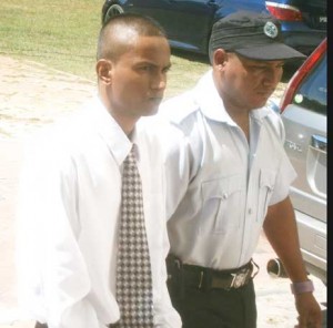 Satrohan Mannaru (left) being escorted to the court.