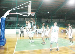 CAN’T TOUCH THIS! Seems to be the words on the mind of Colts’, Sheldon Thomas, who goes aerial against the Surinamese ‘big men’ in the paint to finish an up-and-under layup Saturday night at the Cliff Anderson Sports Hall.