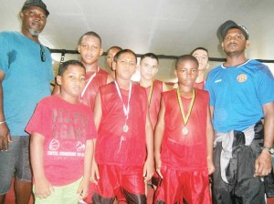 The Barticians are new on the boxing scene but have performed credibly. Here they pause for a photo op shortly before leaving Georgetown for their mining community base. Coaches Shawn Wilson and Tariq Looknauth are extreme left & right respectively.