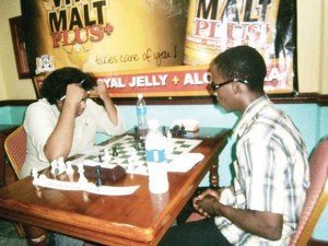 Khan (left) is more perplexed than concentrative as he ponders his next move.