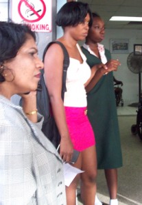 An injured Kiara Parris (in school uniform) in the company of a relative at the Georgetown Public Hospital yesterday 