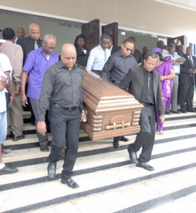 Family members removing the remains of sports personality and veteran broadcaster, Terence ‘Terry’ Holder from the Merriman’s Funeral Home for the church services at the St. Andrew’s Scot’s Kirk, Brickdam.