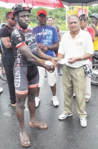 Orville Hinds receives his prize from NSC’s Hassan Mohamed.