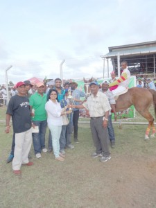 Rose Mohammed of The Jumbo Jet Stable is all smiles as she collects the winning trophy in the feature C class event for Got To Go win. 