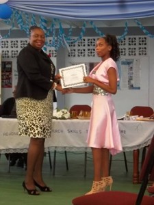 MOE’s Ms. Donna Chapman presents this graduate with her certificate.