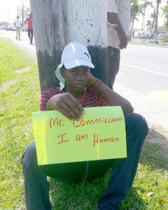 Shot teenager Alex Griffith holding a placard during a protest outside the Office of the Commissioner of Police.