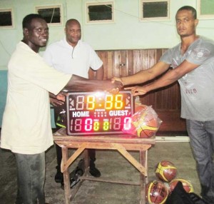  Mark Agard at left, accepts the Shot and Game clocks from  Robert Esseboom (right) while Nigel Hinds (centre) looks on.