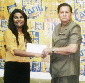 Justice Kennard (right) receives the  cheque from Ms. Darshanie Yussuf.