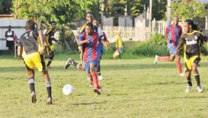 Action between Grove Hi Tech (gold & black) and Timehri Panthers in the Stag Beer EBFA League, yesterday.