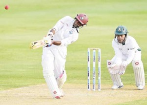 Shivnarine Chanderpaul  lofts over the leg side. (AFP)